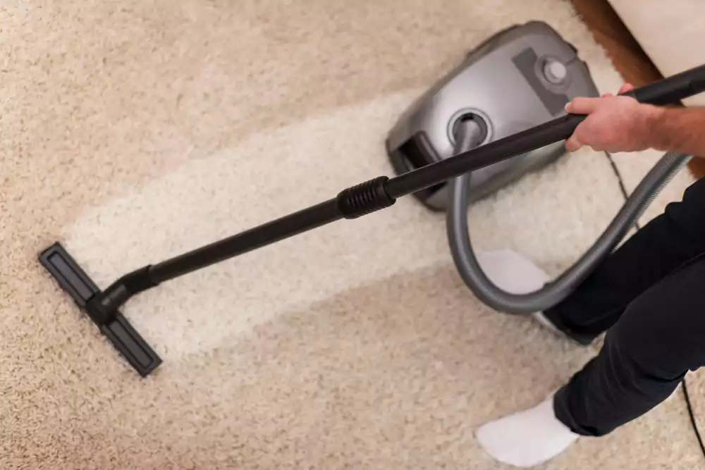 close up vacuuming carpet